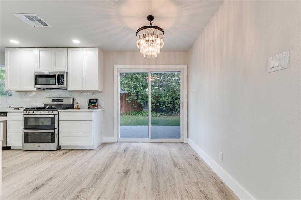 14234 Queens Chapel Road Farmers Branch, TX 75234 - Photo 7 of 21 a view of kitchen with microwave stove refrigerator and cabinets