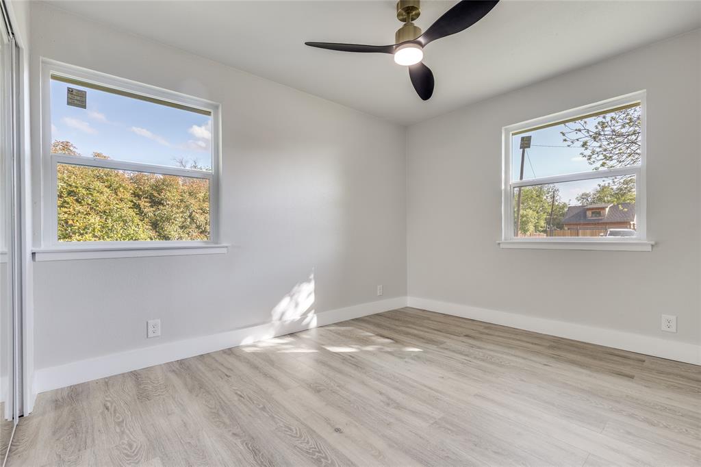 14234 Queens Chapel Road Farmers Branch, TX 75234 - Photo 10 of 21 a view of empty room with wooden floor and fan