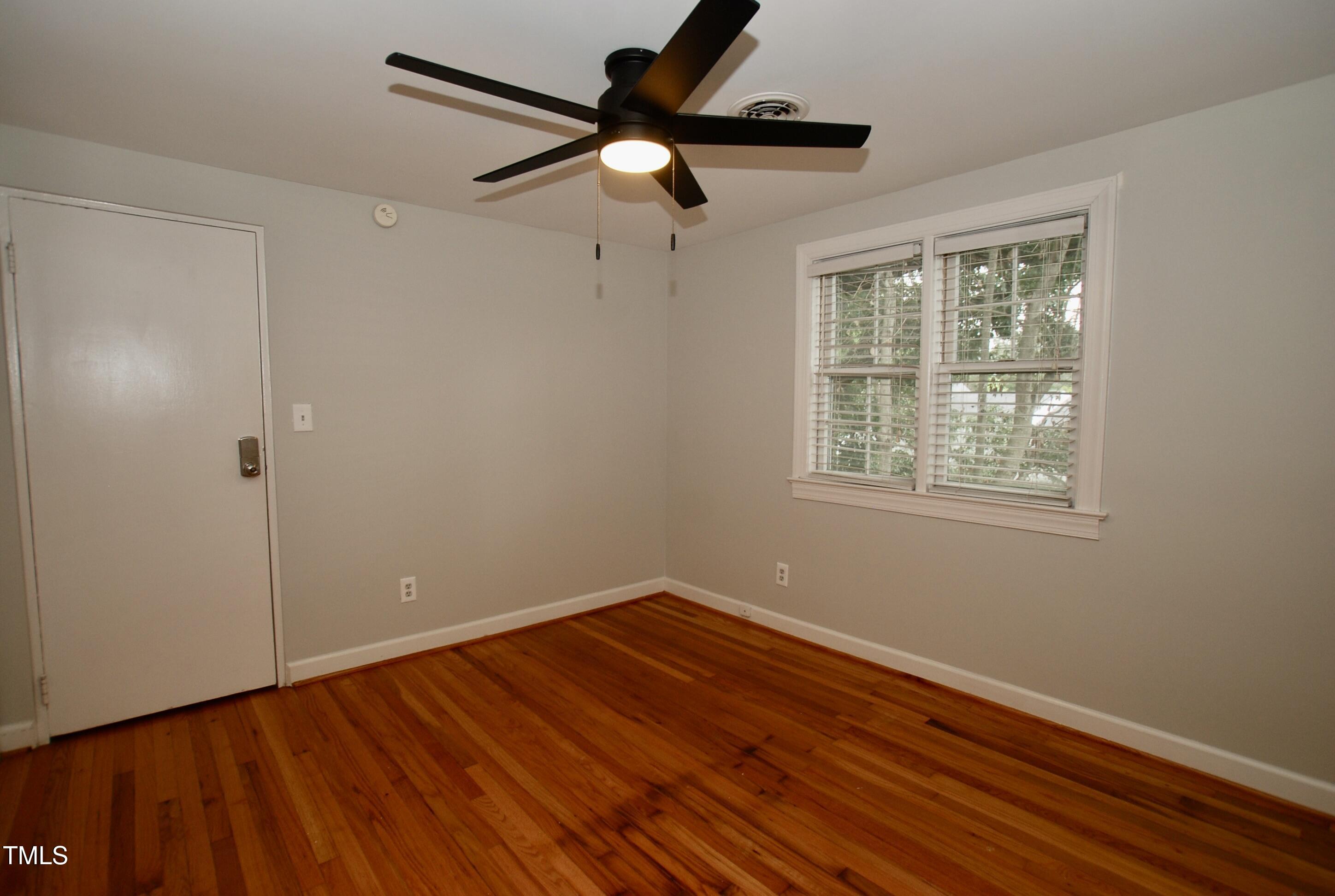 1908 Smallwood Drive Raleigh, NC 27605 - Photo 14 of 30 a view of room with hardwood floor ceiling fan and window