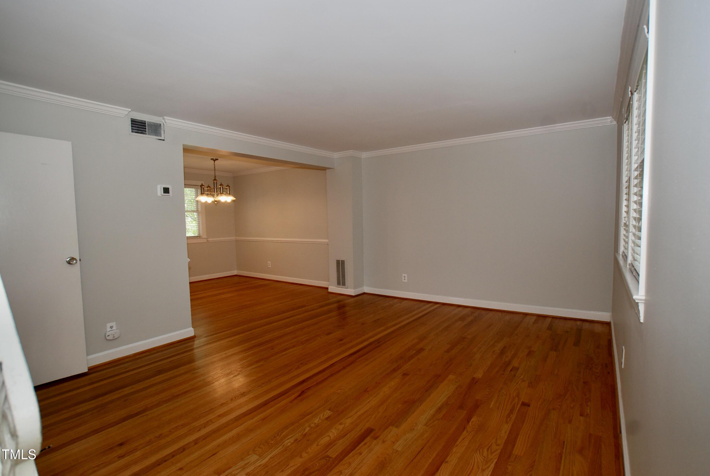 1908 Smallwood Drive Raleigh, NC 27605 - Photo 3 of 30 a view of empty room with wooden floor