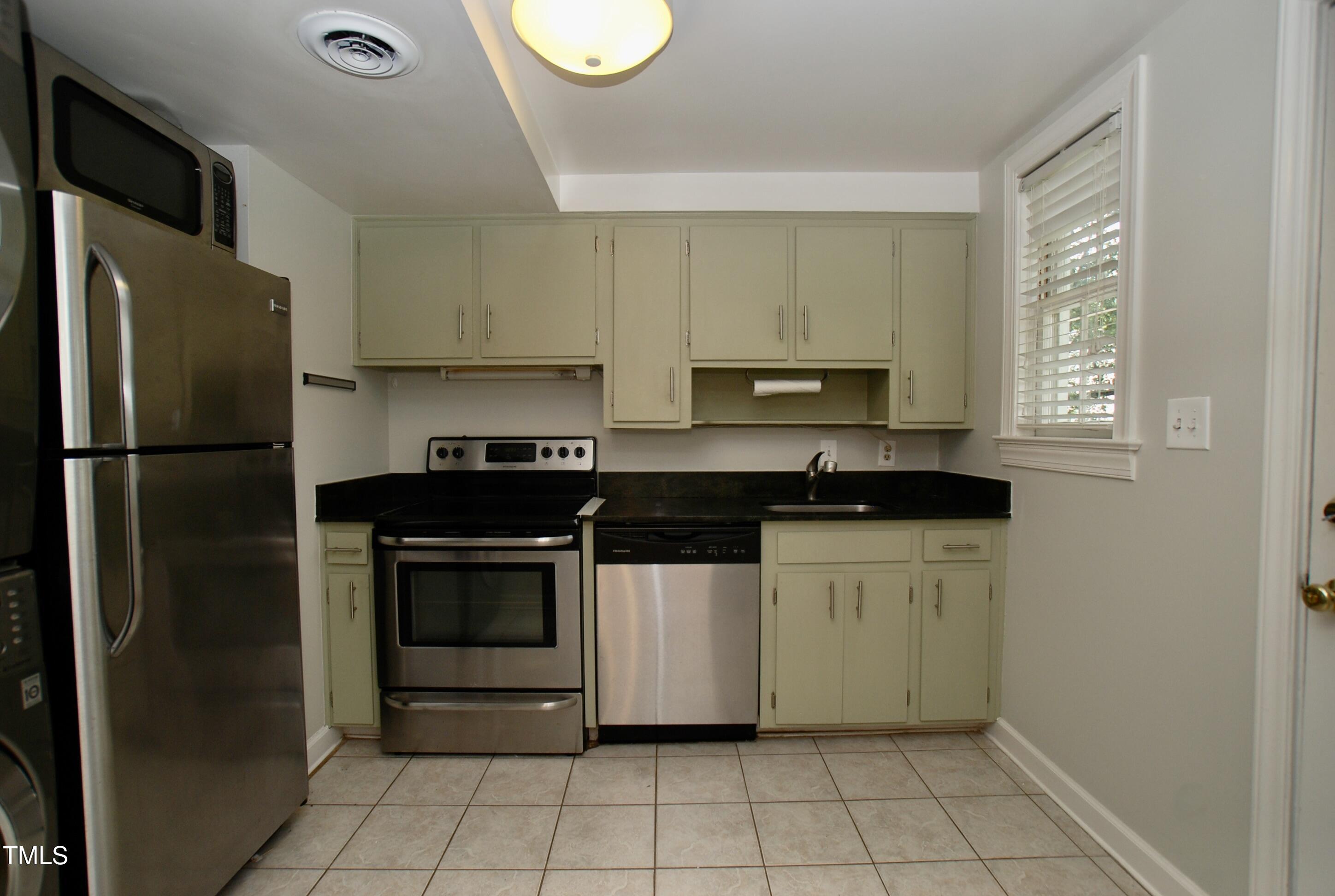 1908 Smallwood Drive Raleigh, NC 27605 - Photo 6 of 30 a kitchen with a stove top oven and refrigerator