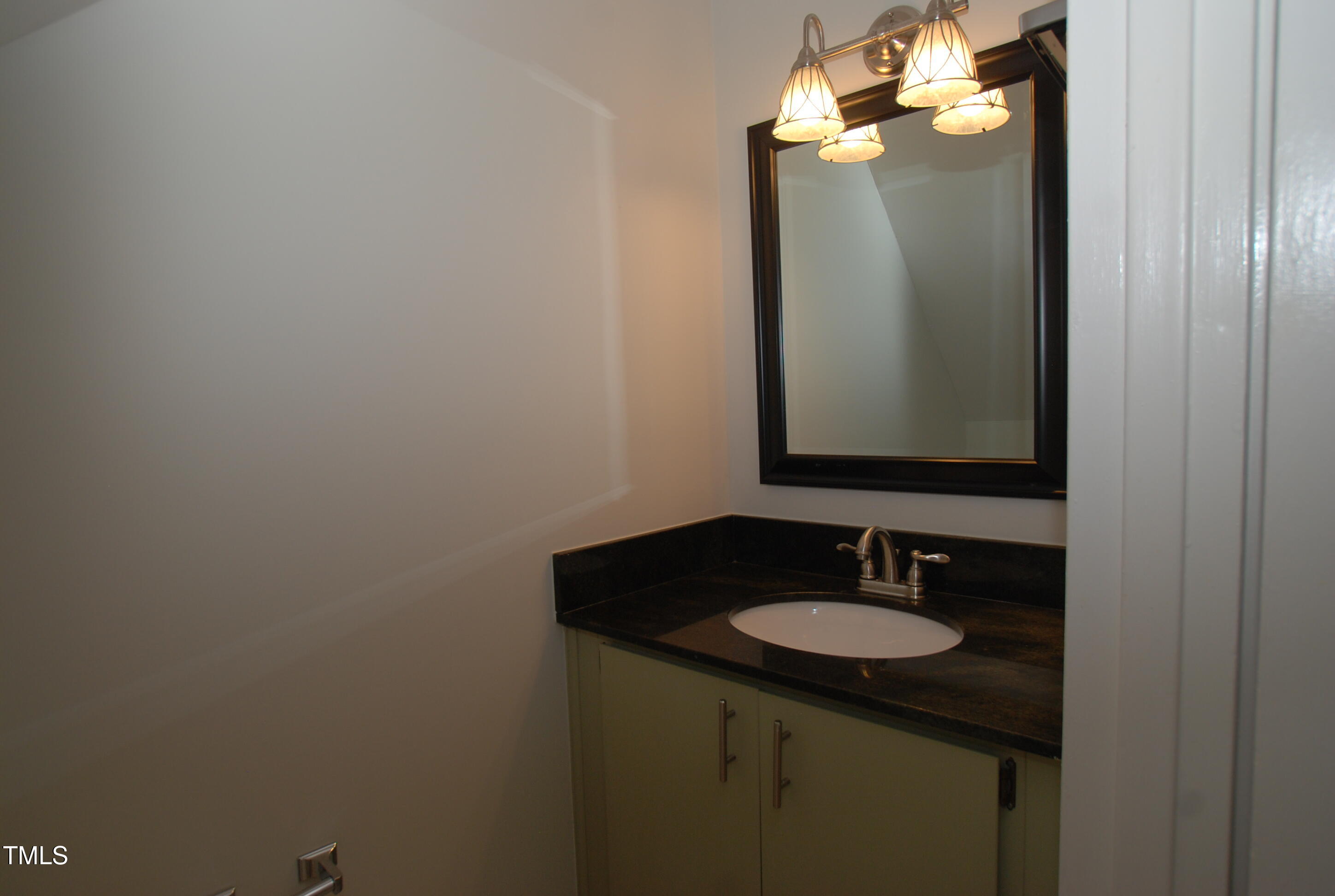 1908 Smallwood Drive Raleigh, NC 27605 - Photo 9 of 30 a bathroom with a sink and a mirror