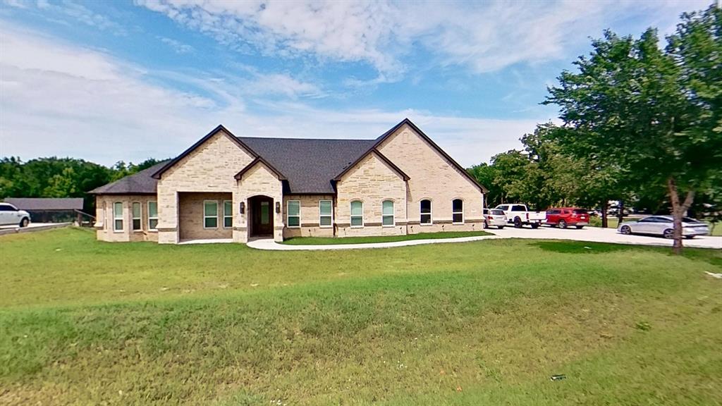 3248 North Cardinal Road Azle, TX 76020 - Photo 3 of 29 Stone exterior with a dark-shingle roof and an arched entry