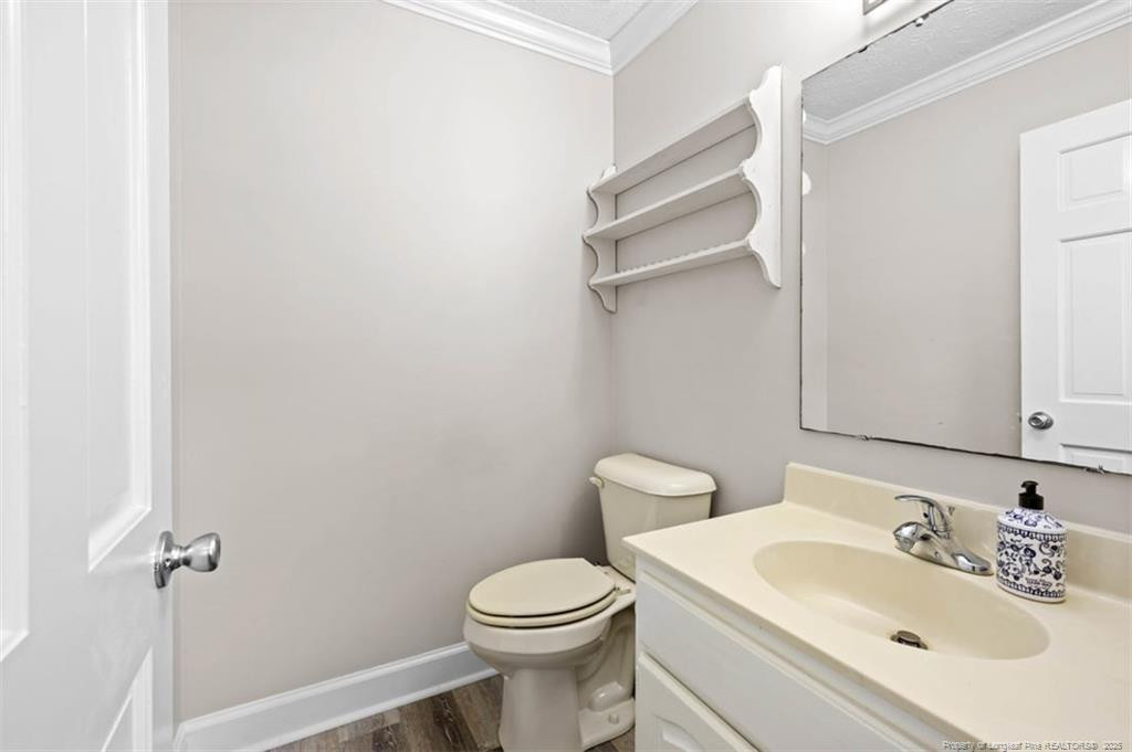 6922 South Staff Road Fayetteville, NC 28306 - Photo 14 of 45 a bathroom with a sink toilet and a mirror