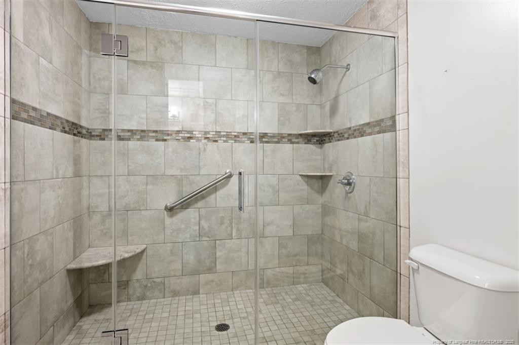 6922 South Staff Road Fayetteville, NC 28306 - Photo 22 of 45 a bathroom with a shower and a toilet