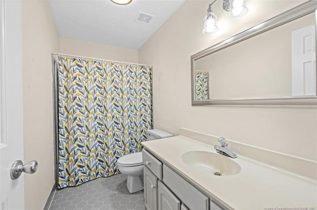 6922 South Staff Road Fayetteville, NC 28306 - Photo 26 of 45 a bathroom with a sink toilet and shower