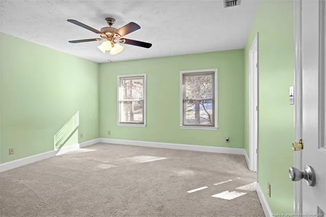 a view of room with window and ceiling fan