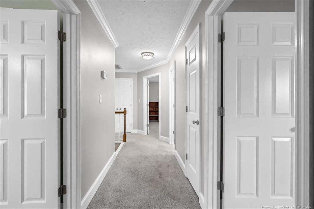 6922 South Staff Road Fayetteville, NC 28306 - Photo 30 of 45 a view of a hallway with wooden shelves