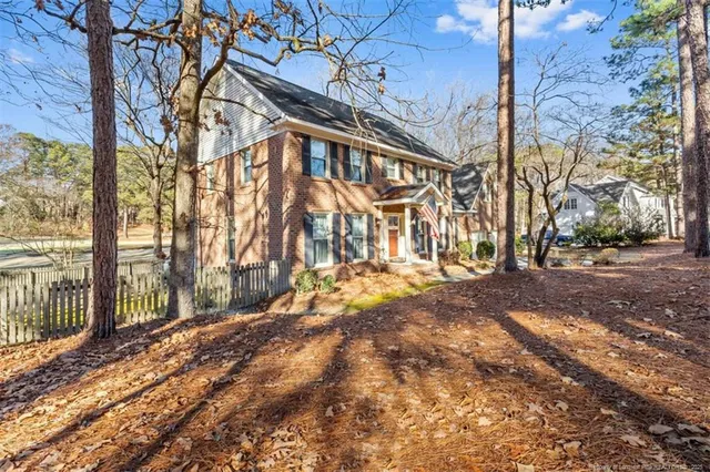 a view of a yard with wooden fence