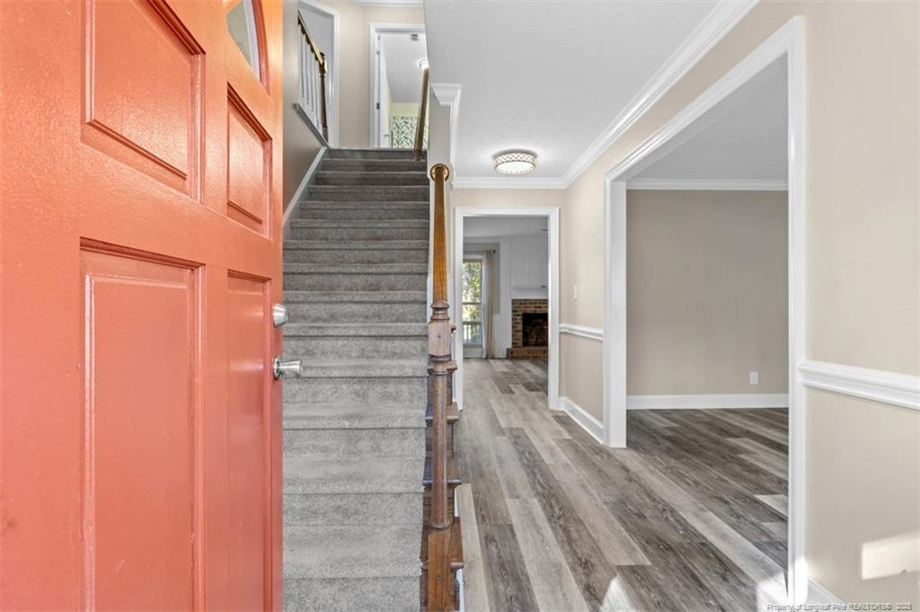 6922 South Staff Road Fayetteville, NC 28306 - Photo 4 of 45 a view of a hallway with wooden floor and staircase