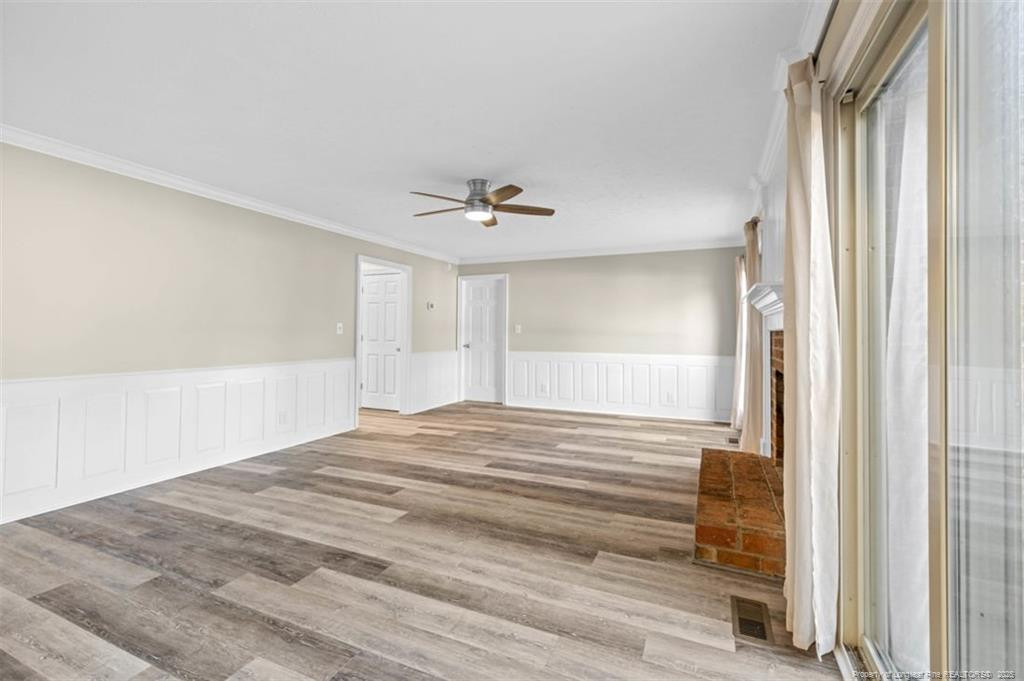 6922 South Staff Road Fayetteville, NC 28306 - Photo 7 of 45 a view of a room with wooden floor and window