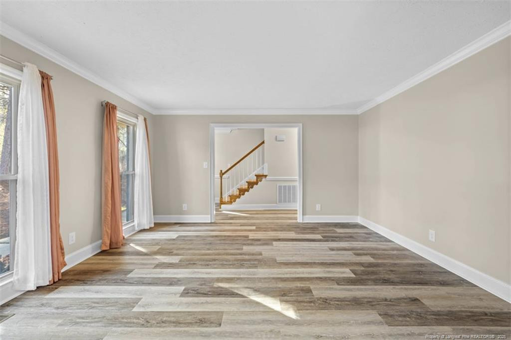 6922 South Staff Road Fayetteville, NC 28306 - Photo 8 of 45 a view of empty room with wooden floor and fan