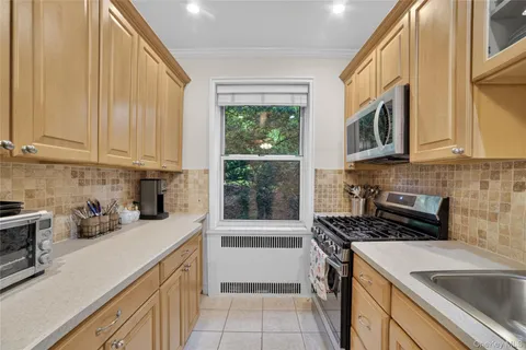 a kitchen that has a sink and a stove