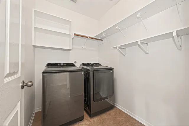 a view of walk in closet with empty racks