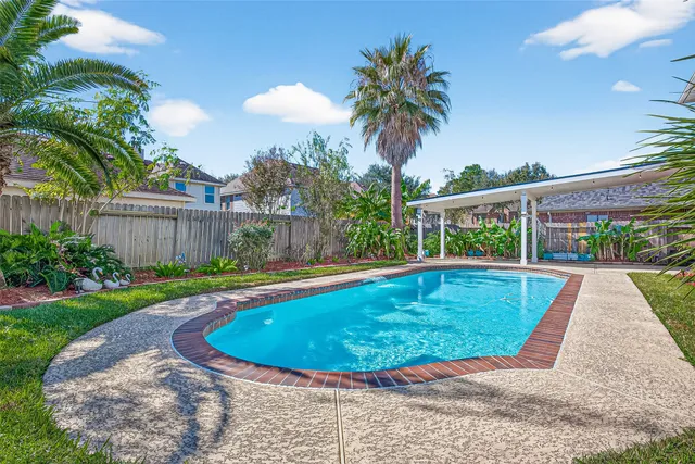 a view of a swimming pool with a patio
