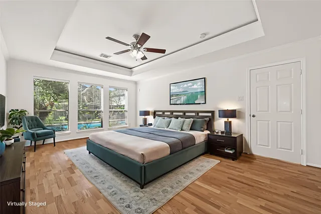 a spacious bedroom with a large bed and a large window