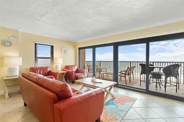 a living room with furniture and a floor to ceiling window