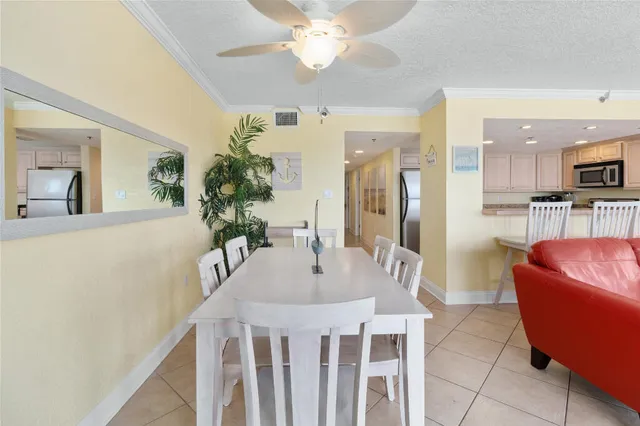 a living room with furniture a dining table and chairs