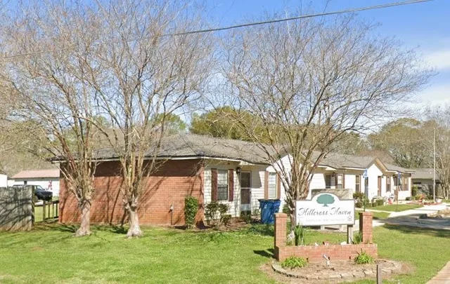 a front view of a house with a yard table and chairs