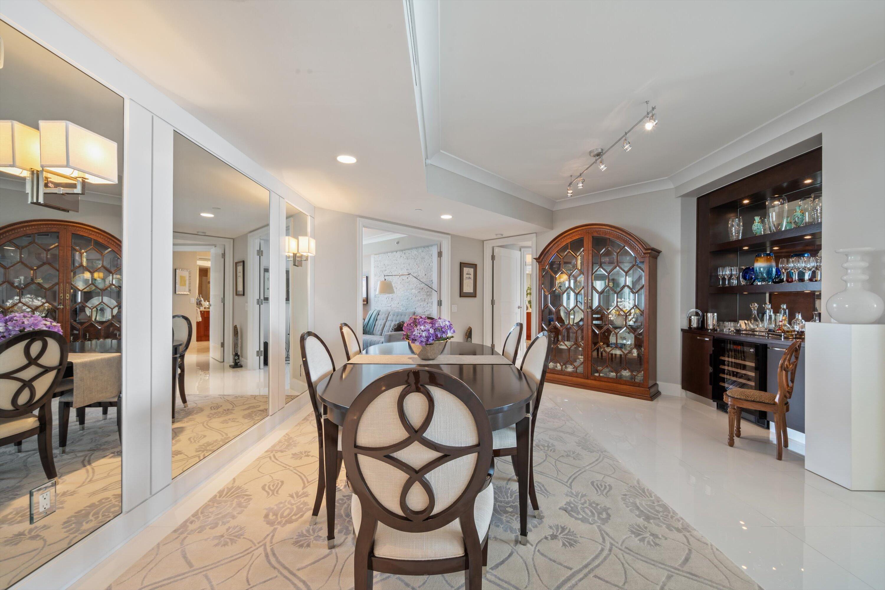2700 North Ocean Drive, Unit 1401B Singer Island, FL 33404 - Photo 11 of 49 a view of a dining room and livingroom with furniture a rug a painting and a chandelier
