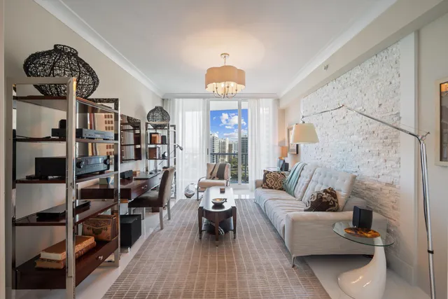 a living room with furniture a rug and a lamp