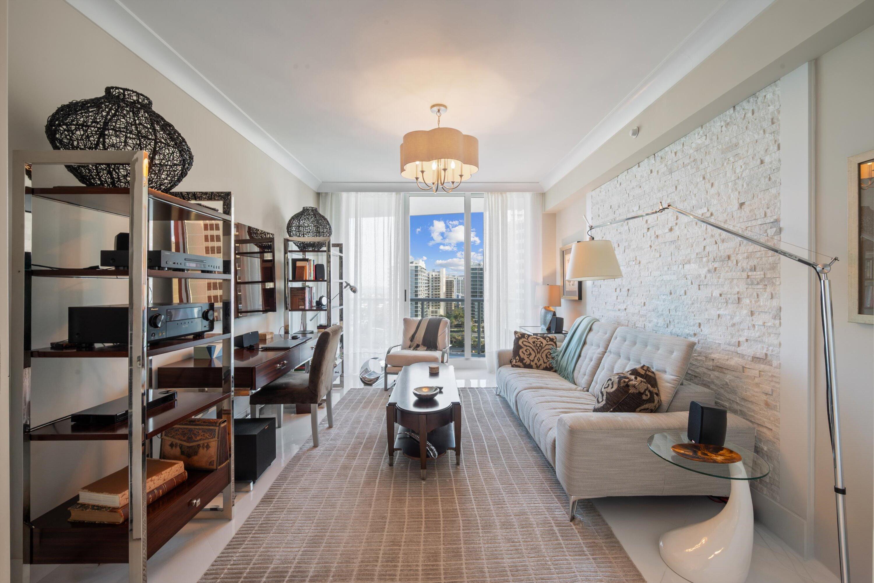 2700 North Ocean Drive, Unit 1401B Singer Island, FL 33404 - Photo 12 of 49 a living room with furniture a rug and a lamp