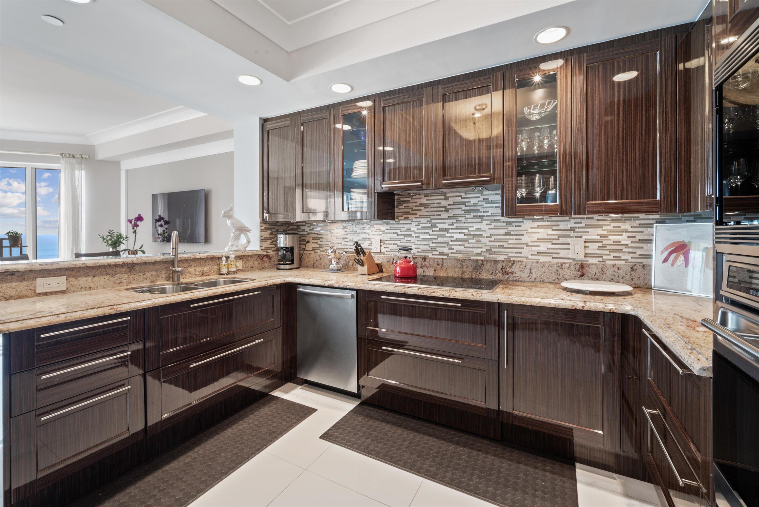 2700 North Ocean Drive, Unit 1401B Singer Island, FL 33404 - Photo 14 of 49 a kitchen with granite countertop stainless steel appliances and sink