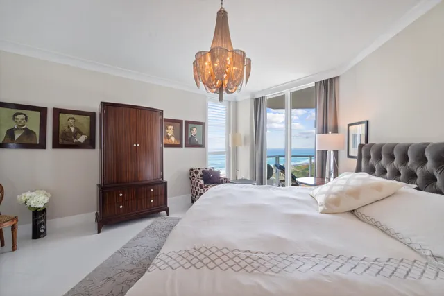 a bedroom with a bed and a chandelier