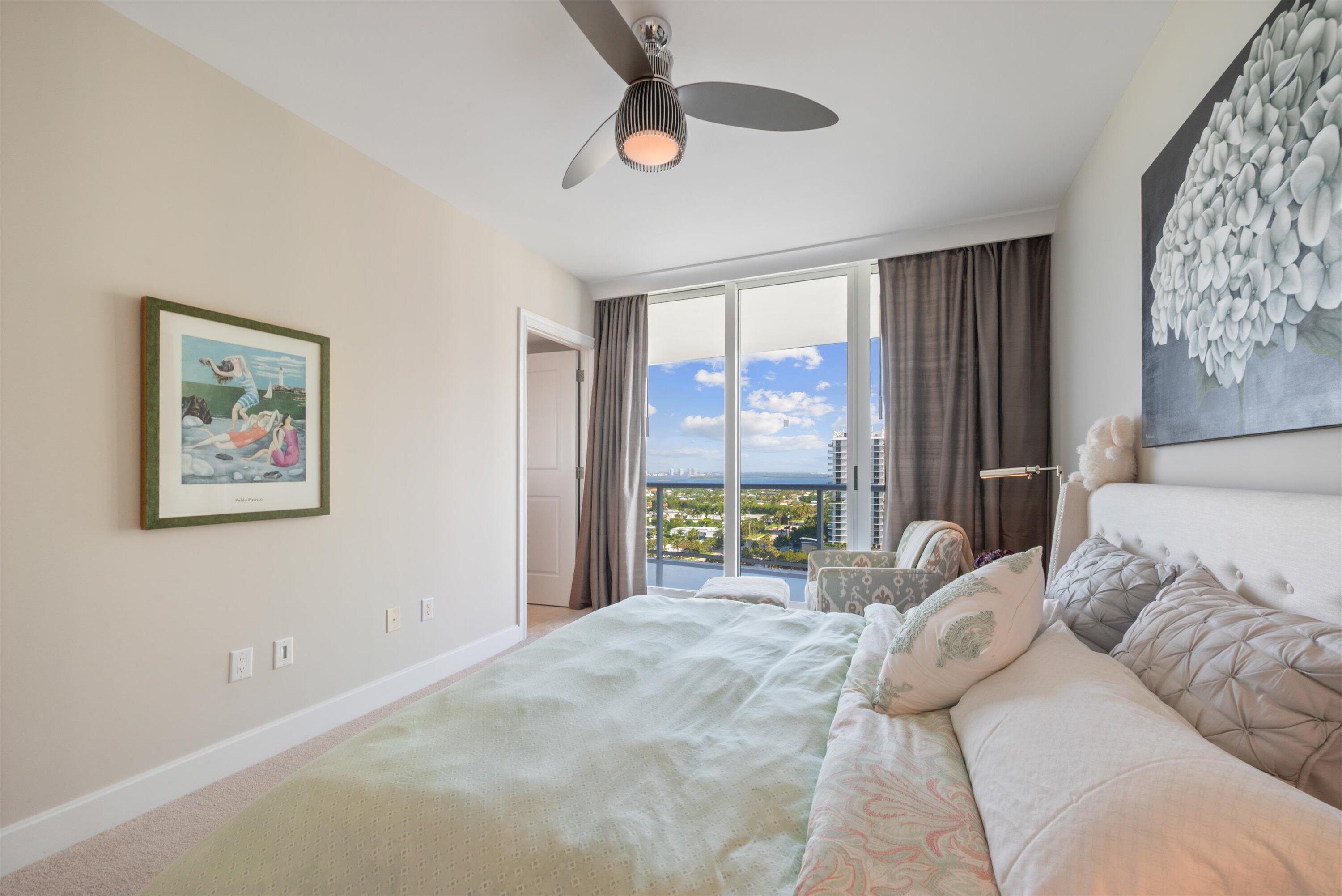 2700 North Ocean Drive, Unit 1401B Singer Island, FL 33404 - Photo 21 of 49 a bedroom with a bed and a large window
