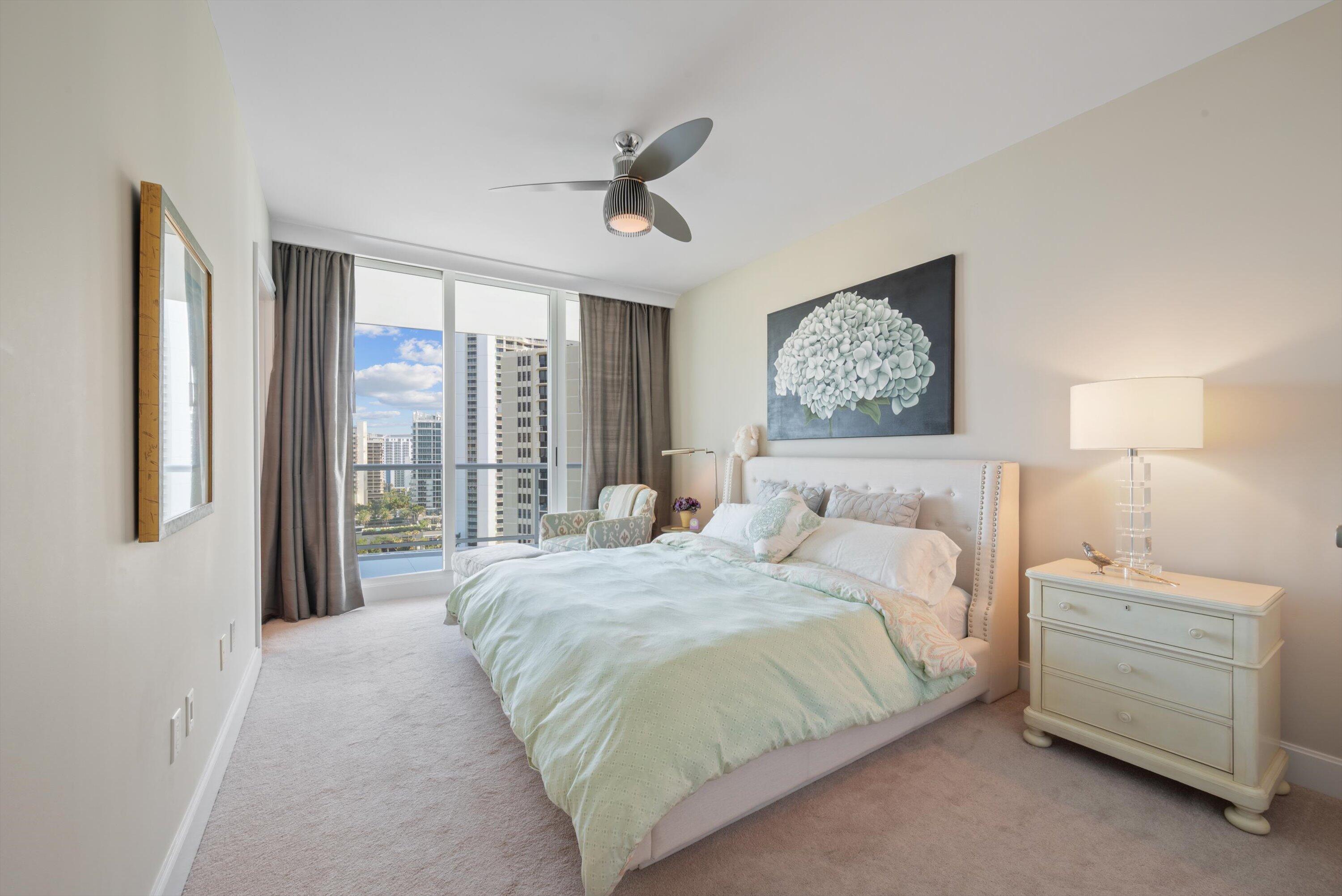 2700 North Ocean Drive, Unit 1401B Singer Island, FL 33404 - Photo 22 of 49 a bedroom with a bed mirror and window