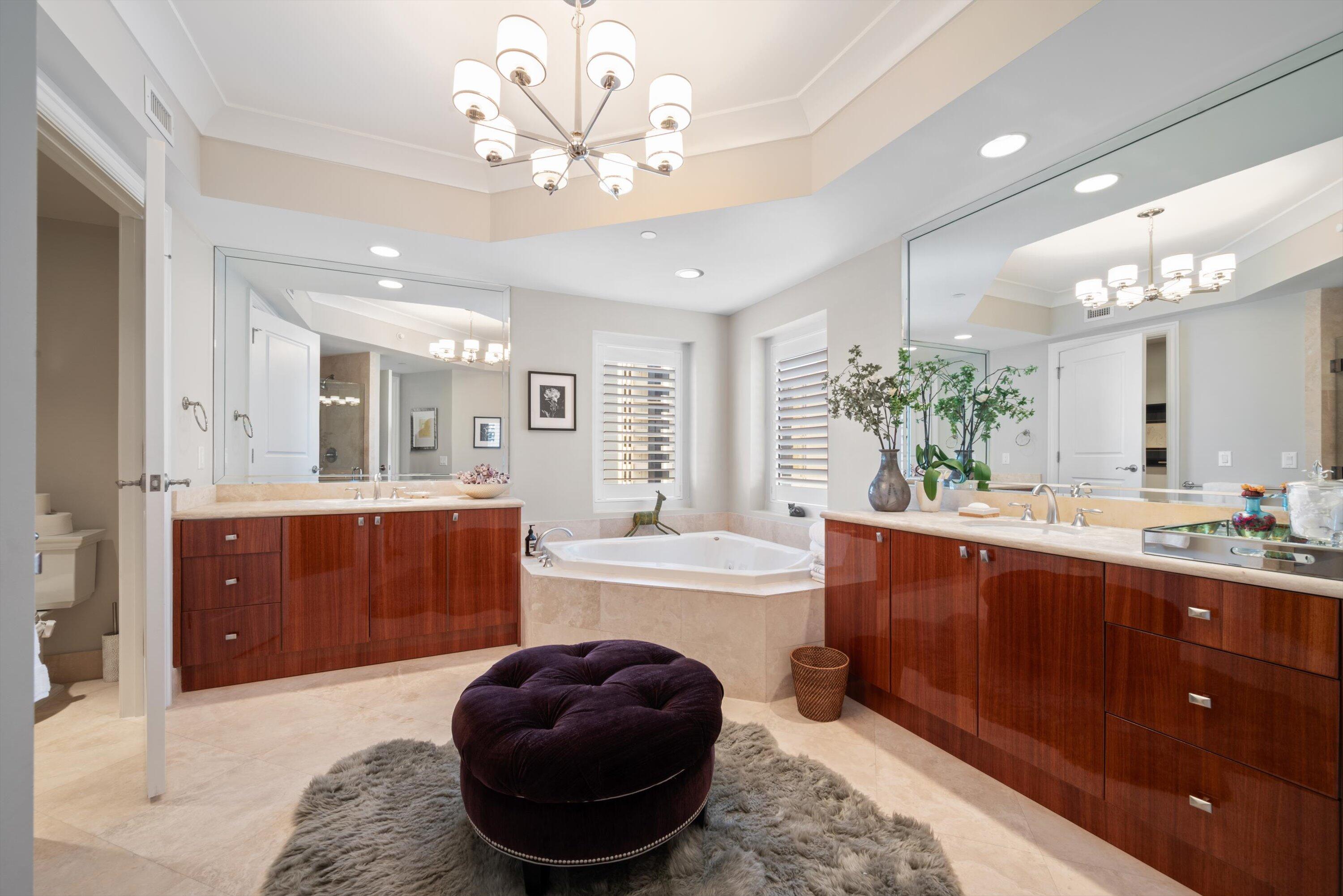 2700 North Ocean Drive, Unit 1401B Singer Island, FL 33404 - Photo 24 of 49 a spacious bathroom with a tub sink and mirror