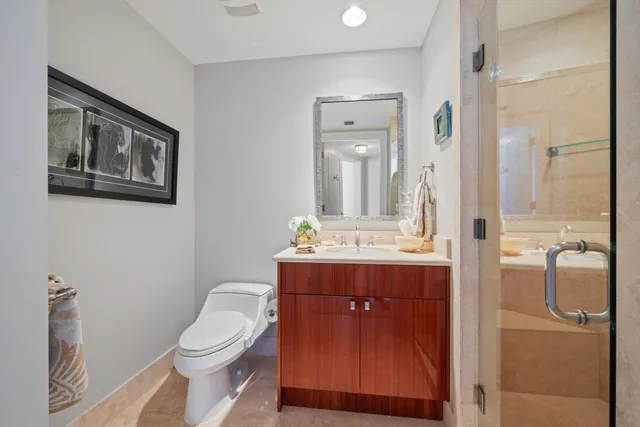 a bathroom with a toilet sink and mirror