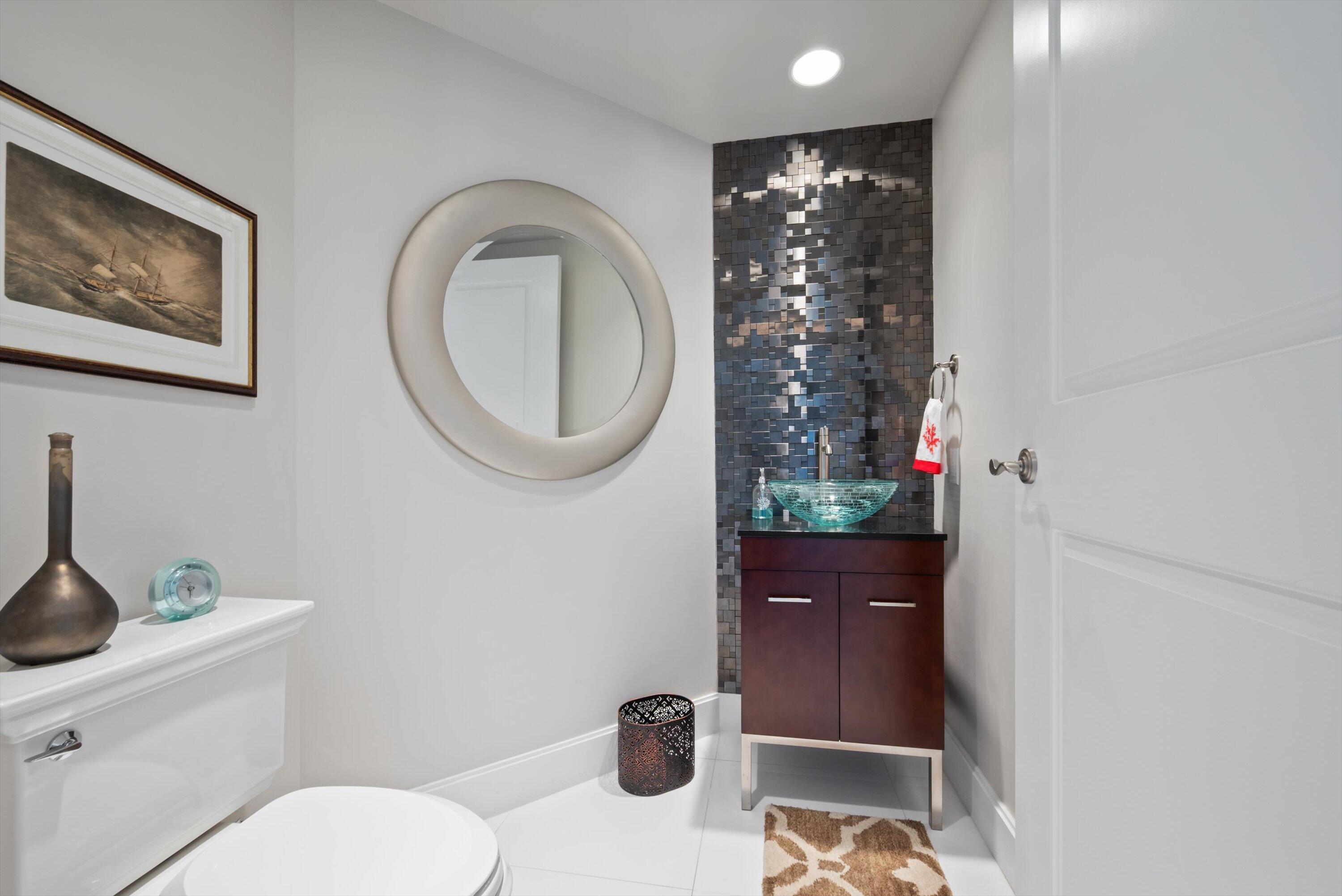 2700 North Ocean Drive, Unit 1401B Singer Island, FL 33404 - Photo 29 of 49 a bathroom with a toilet and a sink