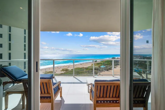 a view of a balcony with floor to ceiling windows with wooden floor