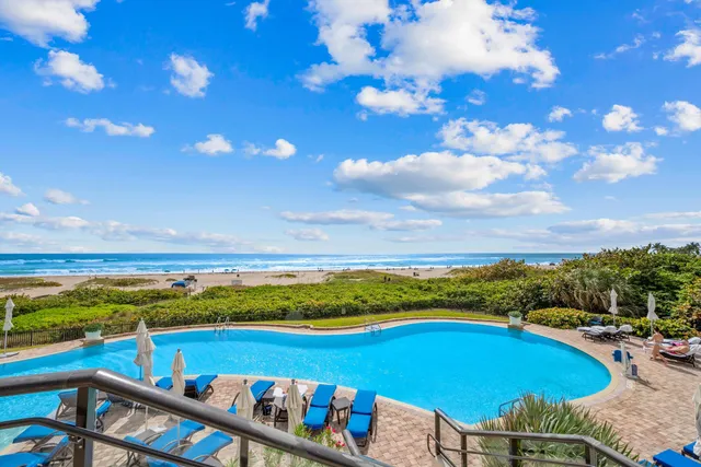 a view of a swimming pool with an outdoor seating a yard swimming pool and ocean view