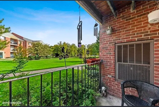 a front view of a house with a yard table and chairs