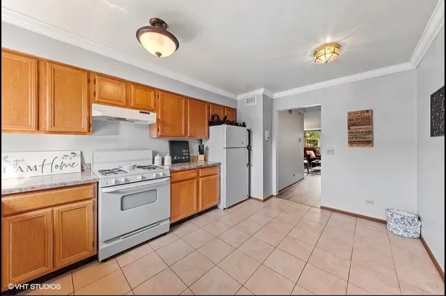 a kitchen with a stove a refrigerator and a sink