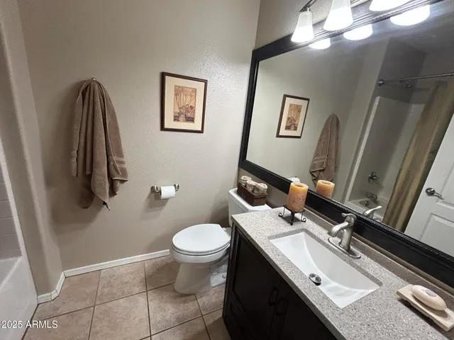 a bathroom with a sink mirror vanity and toilet