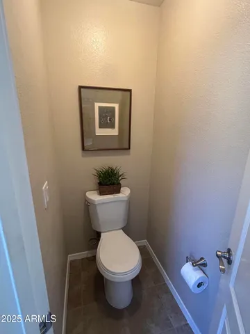 a white toilet sitting next to a bathroom sink