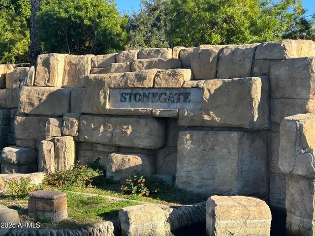 a view of an outdoor sitting area with brick wall