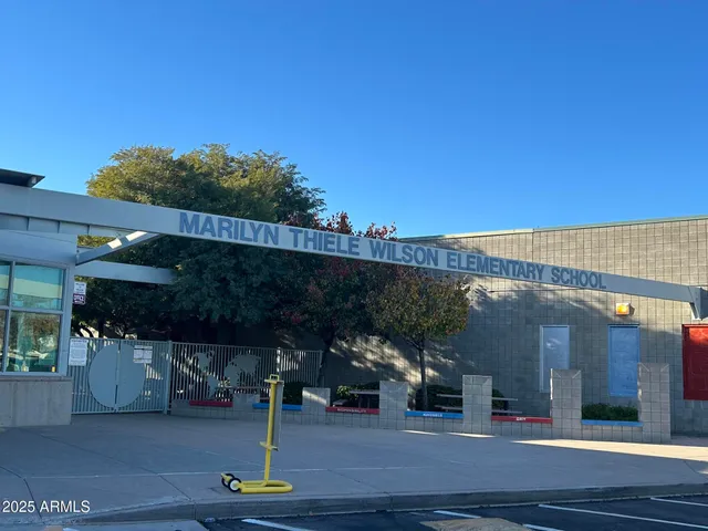 a view of building along with the road and shops