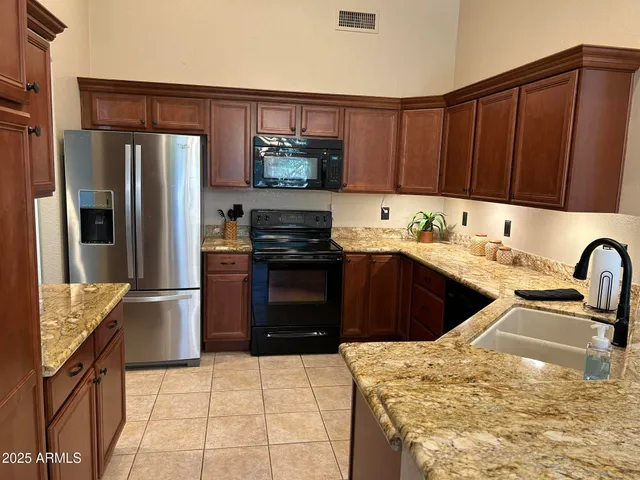 a kitchen with a sink appliances and cabinets