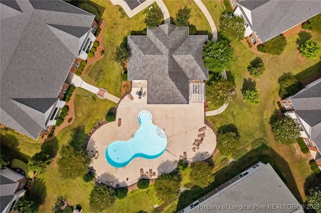 an aerial view of a house with a swimming pool