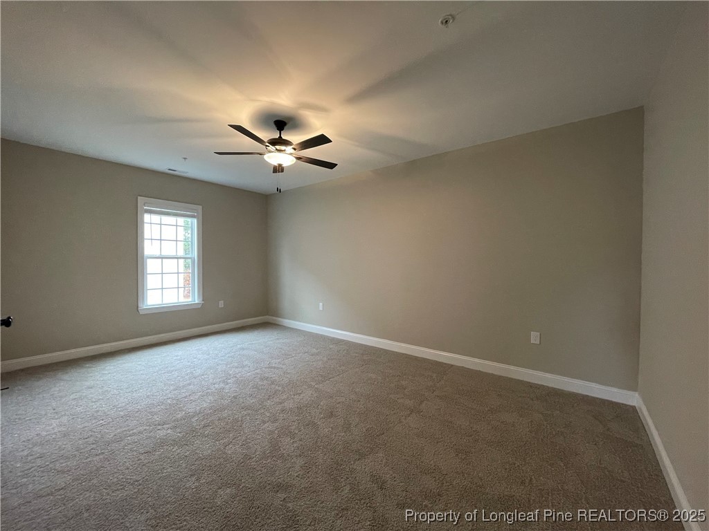 220 Gallery Drive, Unit 201 Spring Lake, NC 28390 - Photo 5 of 17 an empty room with a ceiling fan and a window