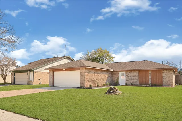 a front view of a house with a garden and yard