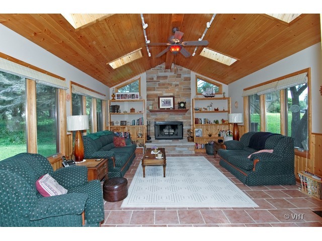 11N918 Almora Terrace Elgin, IL 60124 - Photo 2 of 10 a living room with furniture a fireplace and a large window