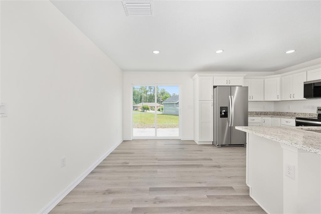 13019 Northeast 7th Loop Silver Springs, FL 34488 - Photo 16 of 35 a view of a kitchen with a sink and a refrigerator