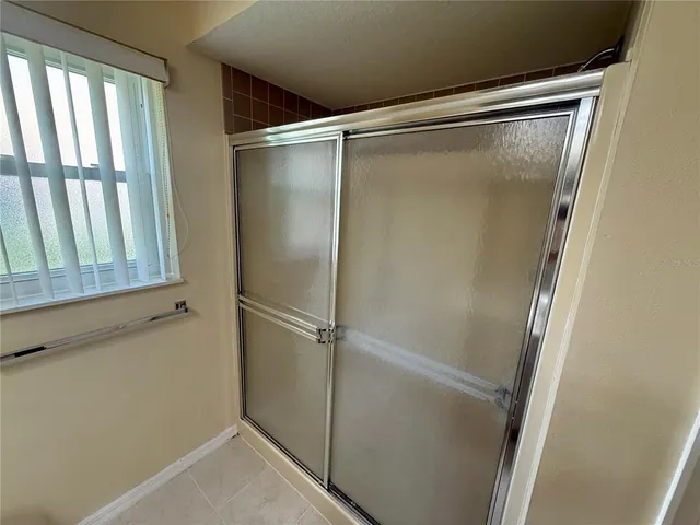 a bathroom with a glass shower door