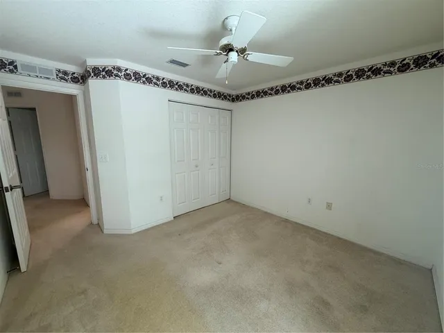 a very nice looking room with a chandelier fan