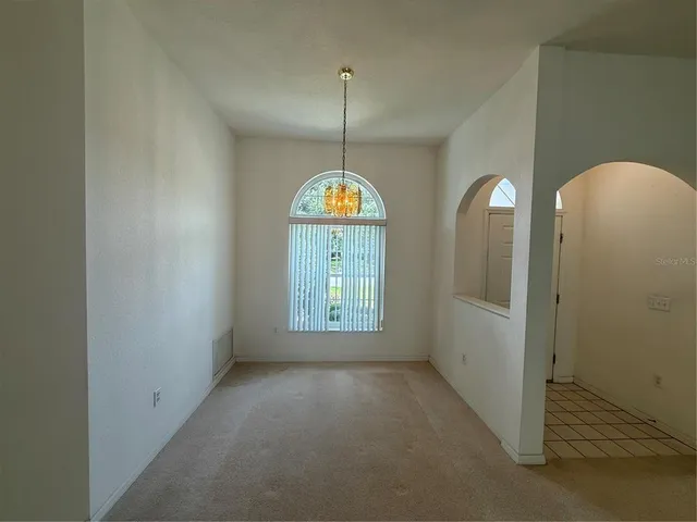a view of a room with window and entryway